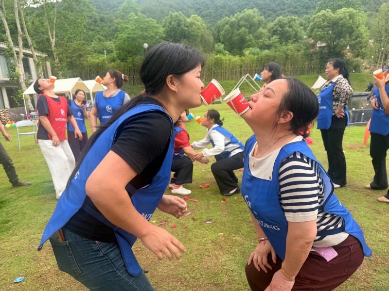 Team members competing in coordination game during team building event