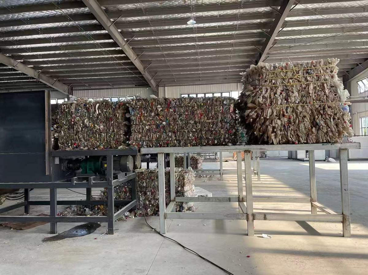 Bales of recycled PET bottles at the start of the RPET fabric supply chain