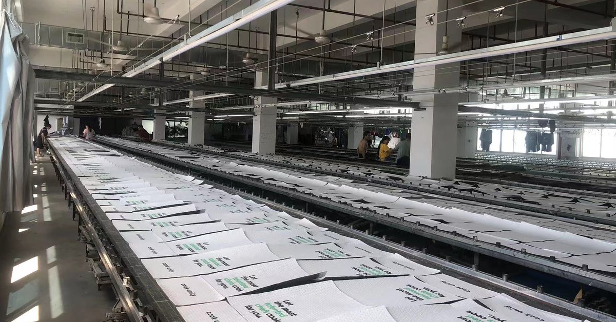 Screen-printed custom logo promotional bags drying on the printing line at the Weihuang factory